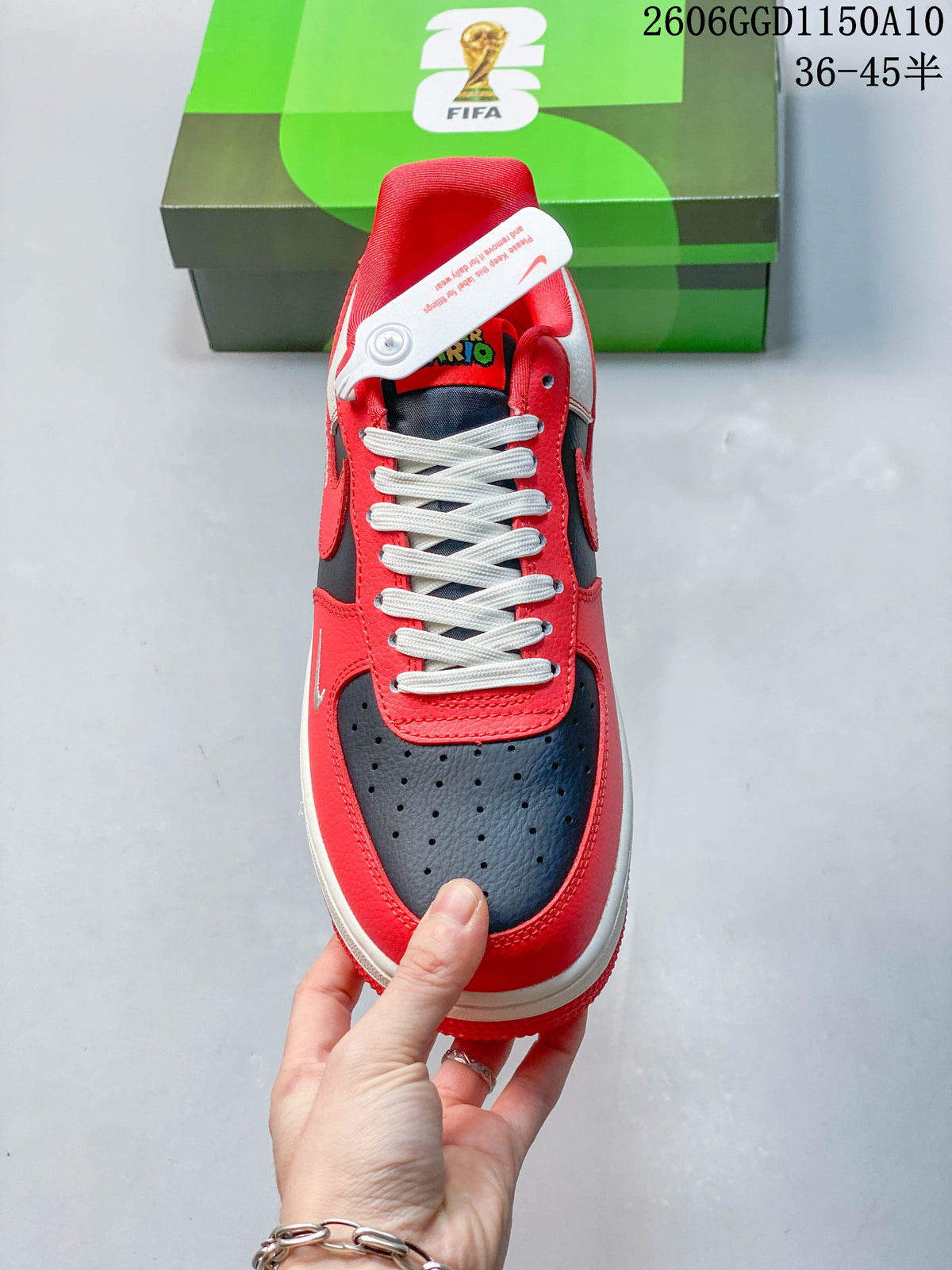 Top view showing perforated navy toe panel, red overlays, and light-colored laces.