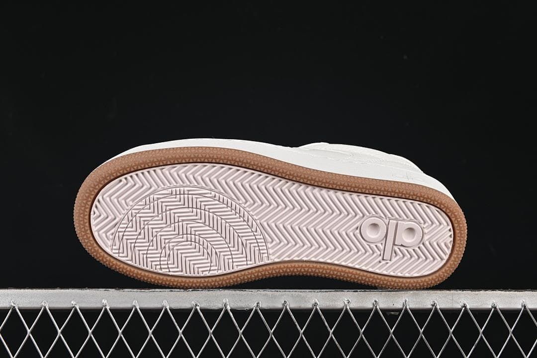 Underside view showing the patterned outsole and gum-colored edge