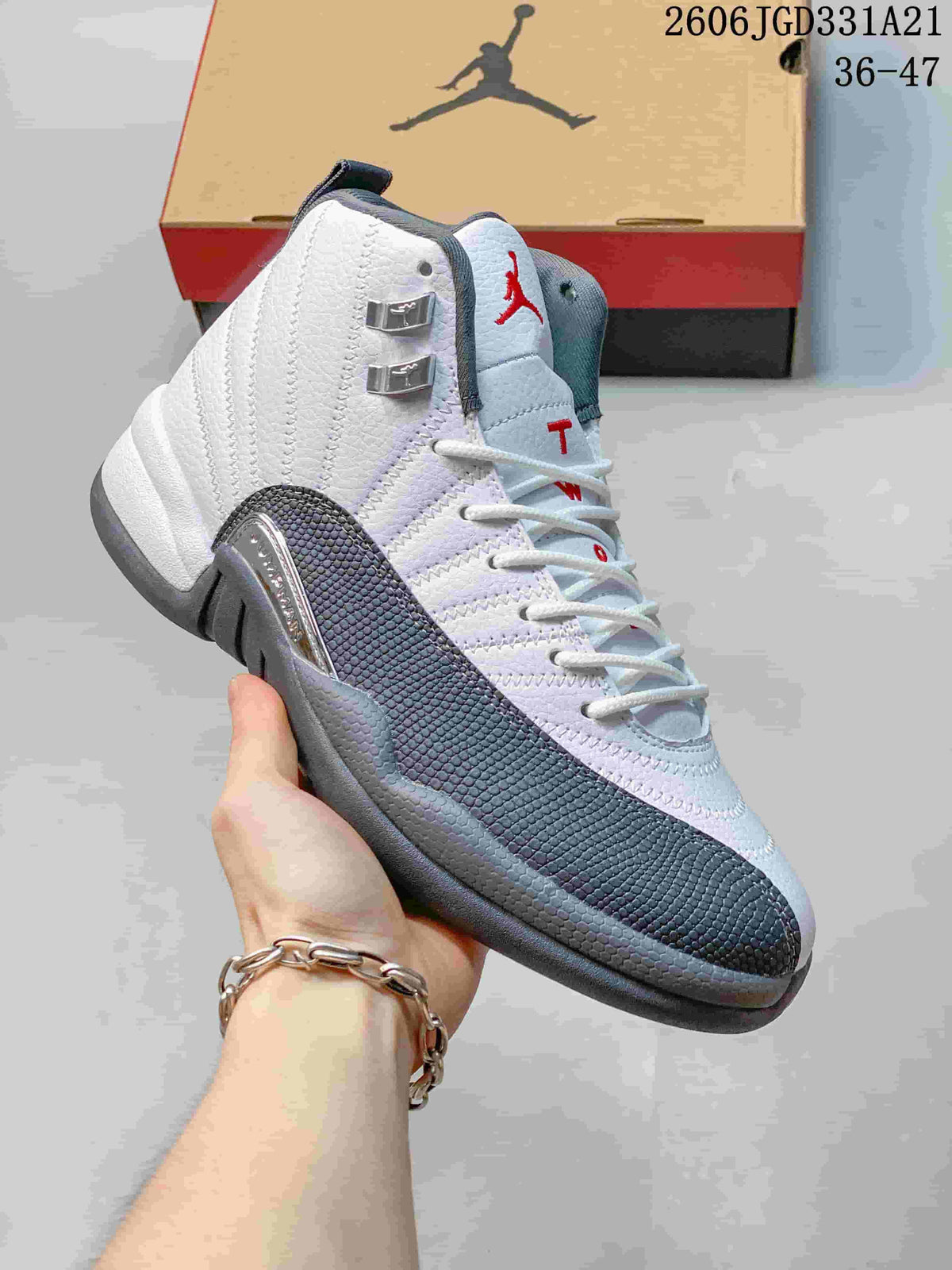 Close-up of a white and gray high-top Air Jordan 12 shoe showing the side panel and lace hardware