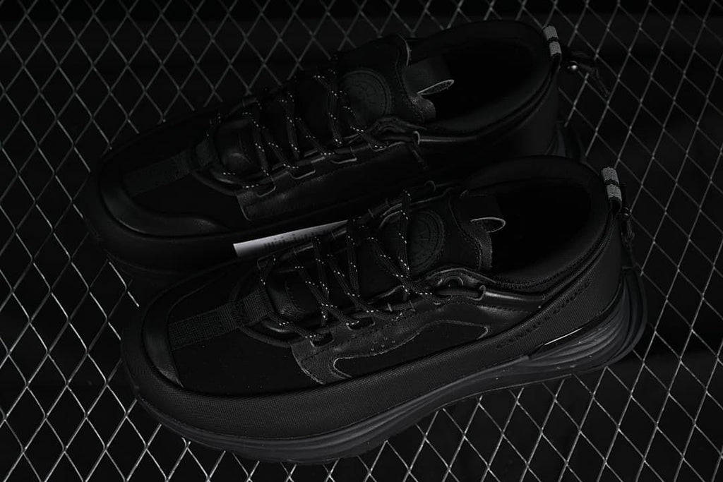 Pair of black trail sneakers shown from above at an angle