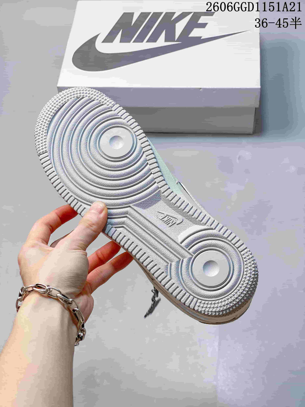 Close-up of the textured outsole on a cream Nike Air Force 1 sneaker