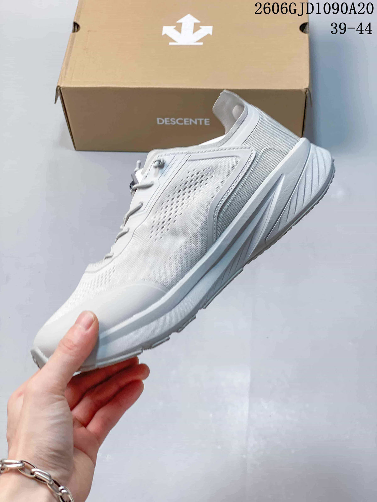 Side view of the white low-top running shoe