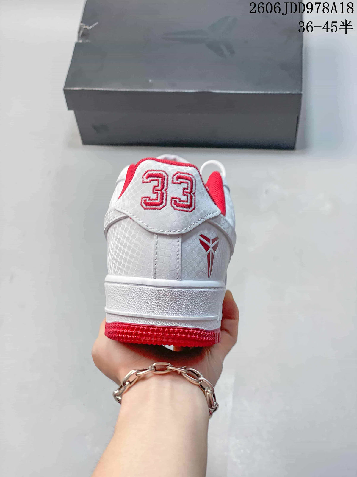 Rear view showing the white textured heel, red number 33 detail, and Kobe-themed emblem.