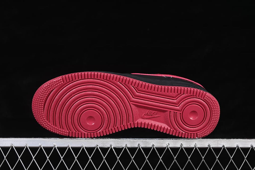 Underside view of the red outsole with circular tread patterns