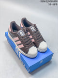Dark brown adidas Superstar 2 sneakers with pink stripes and light shell toes, pictured on a blue shoe box.