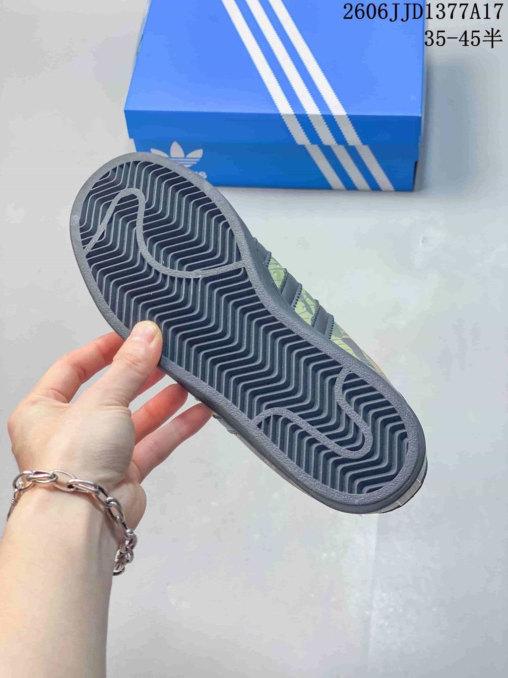 Close-up of the dark patterned outsole on a camouflage Superstar sneaker