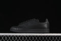 Side profile of an all-black Adidas Stan Smith sneaker