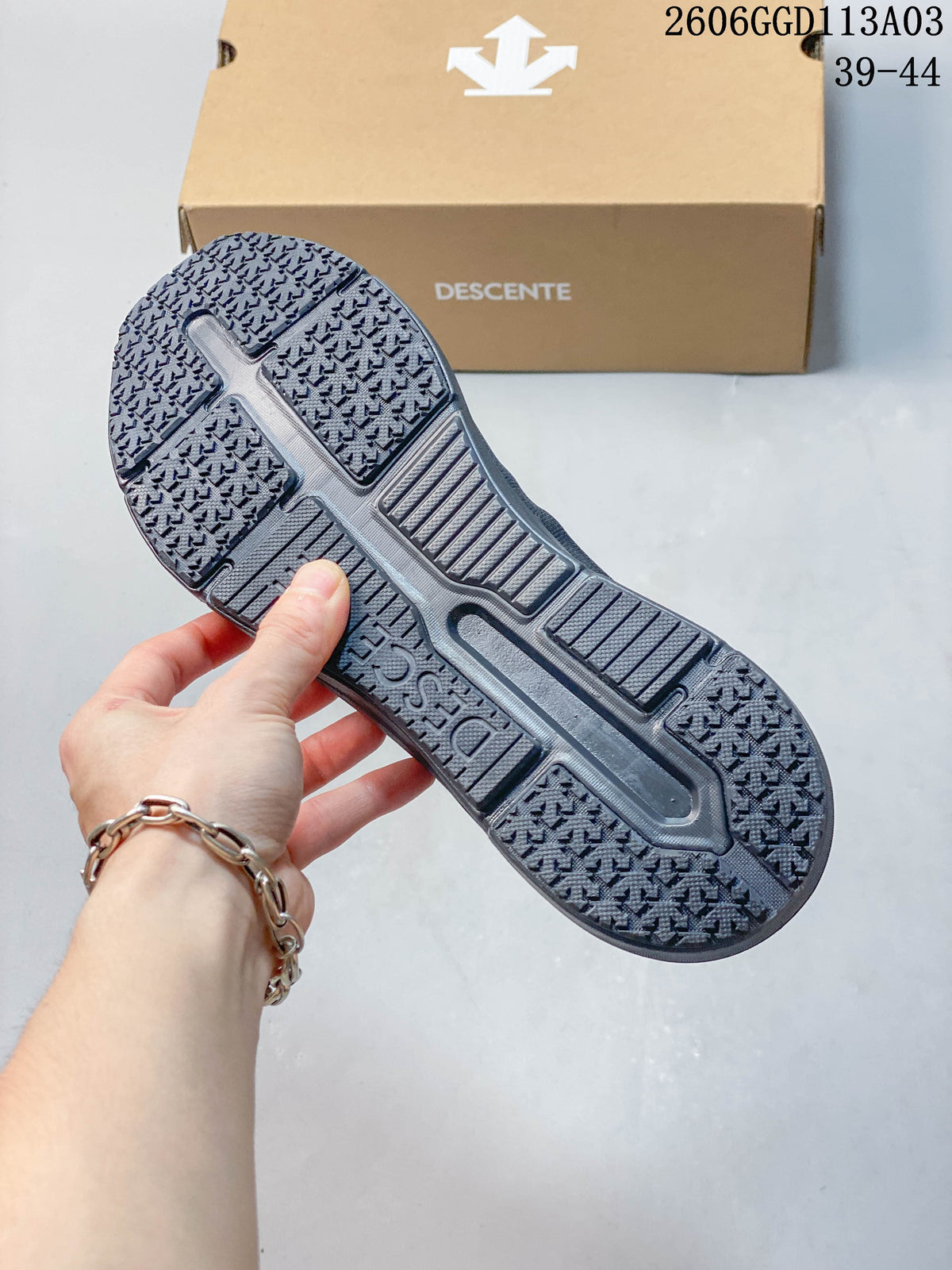 Close-up of the textured outsole on a gray DESCENTE shoe