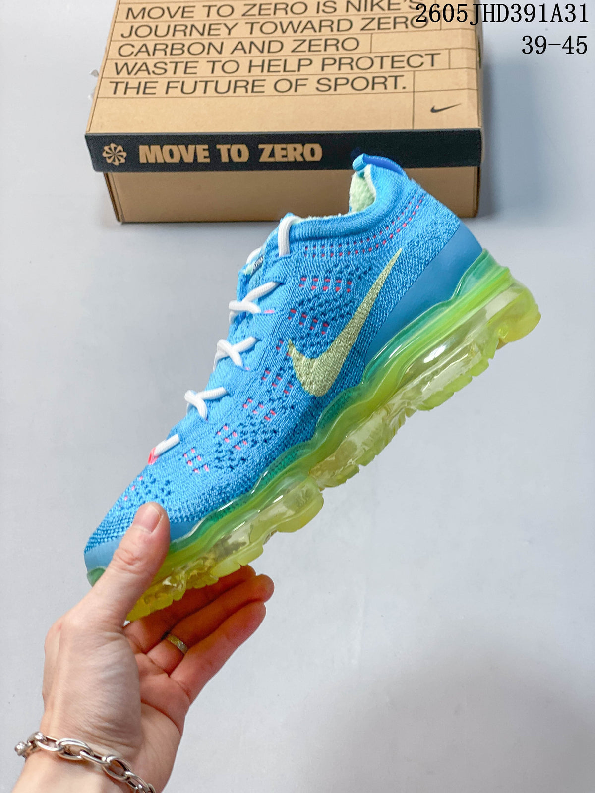 Side view of a blue knitted-style shoe with a pale yellow Swoosh and lime-green sole