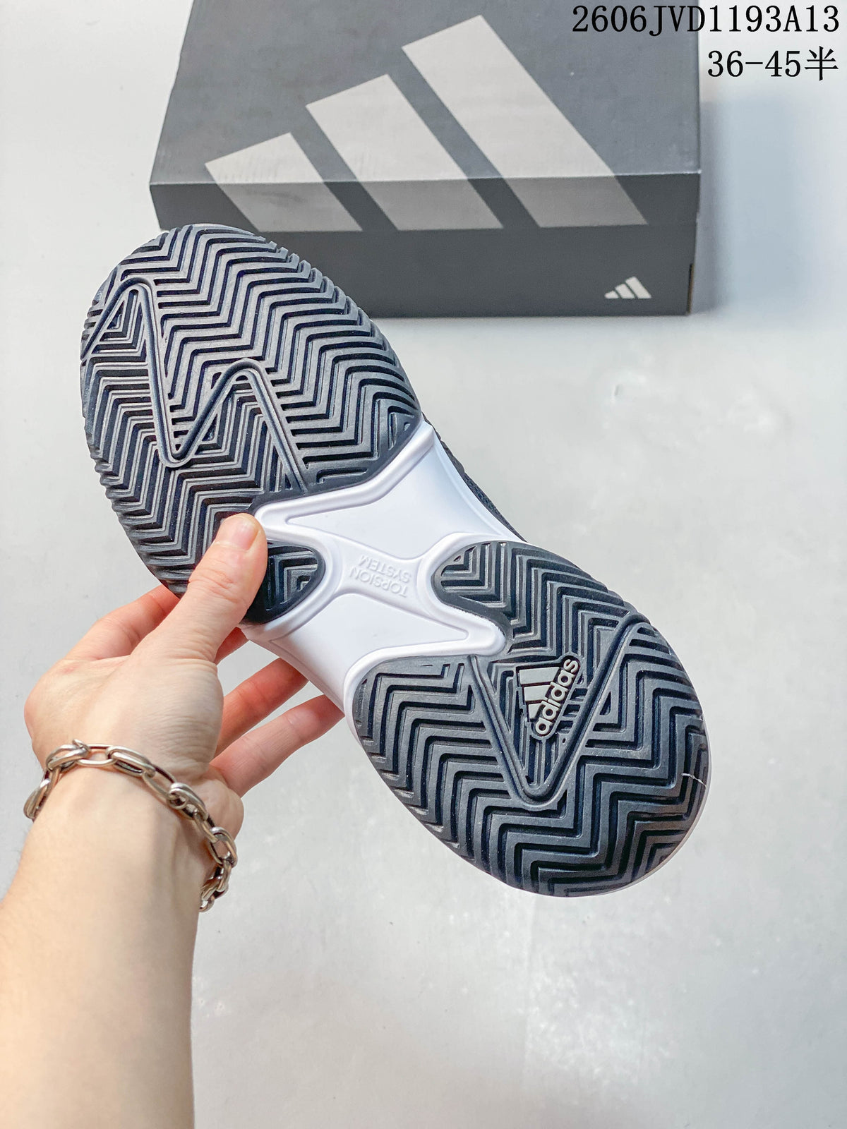 Close-up of the patterned outsole on an Adidas Barricade 13 shoe