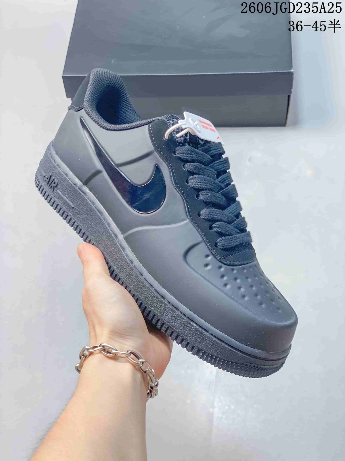 Charcoal low-top sneaker shown from the side, highlighting the Swoosh detail and Air-marked midsole