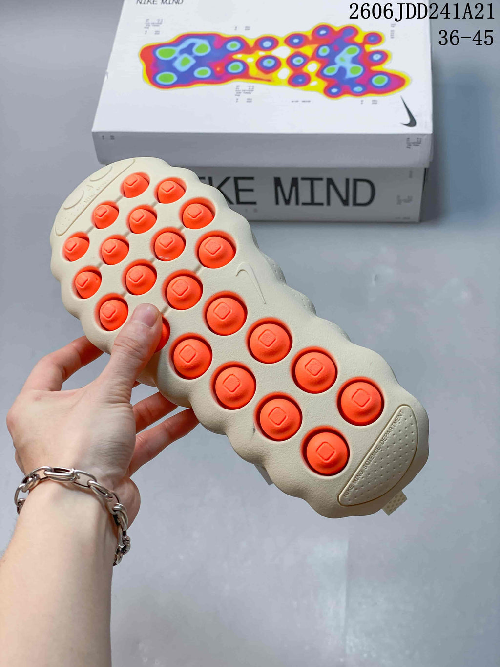 Nike Mind sneaker outsole with orange circular pods