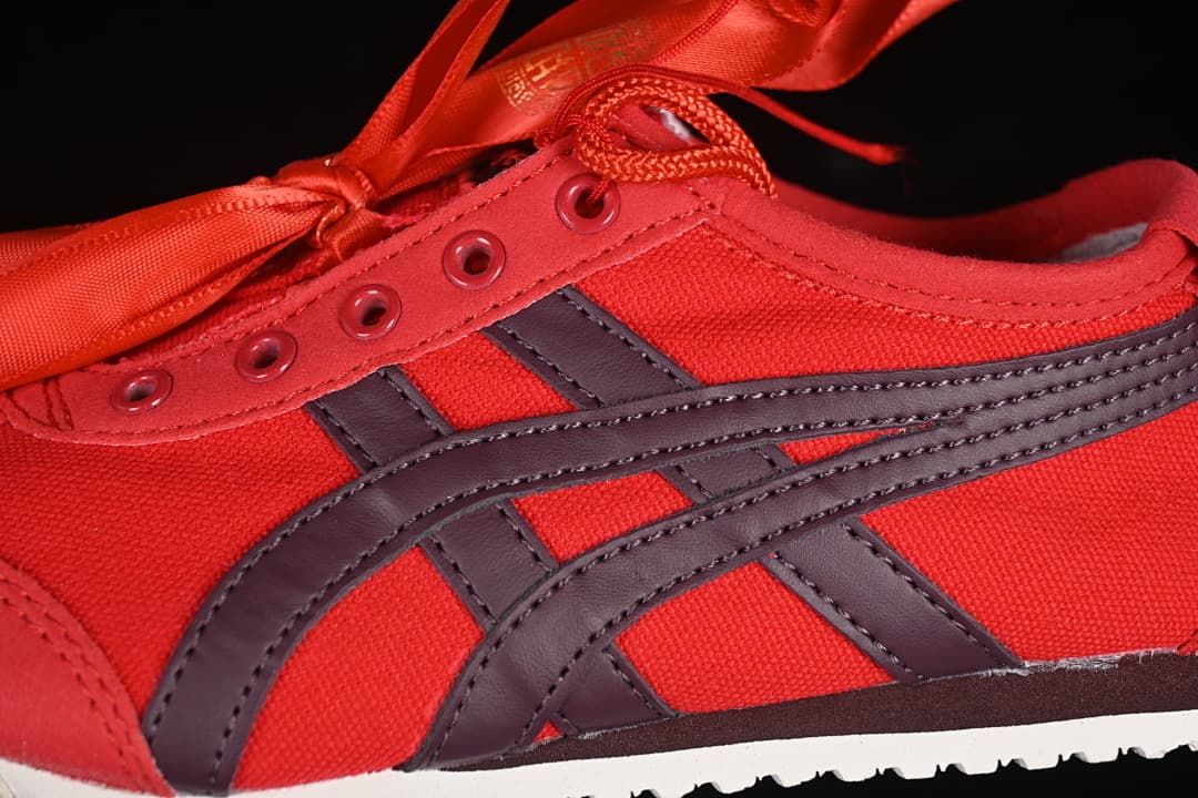 Close-up of the red upper, dark side stripes, eyelets and laces