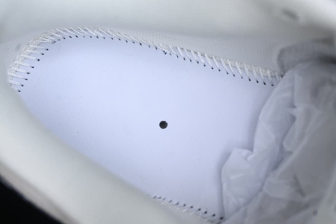 Close-up view inside the sneaker showing the insole stitching.