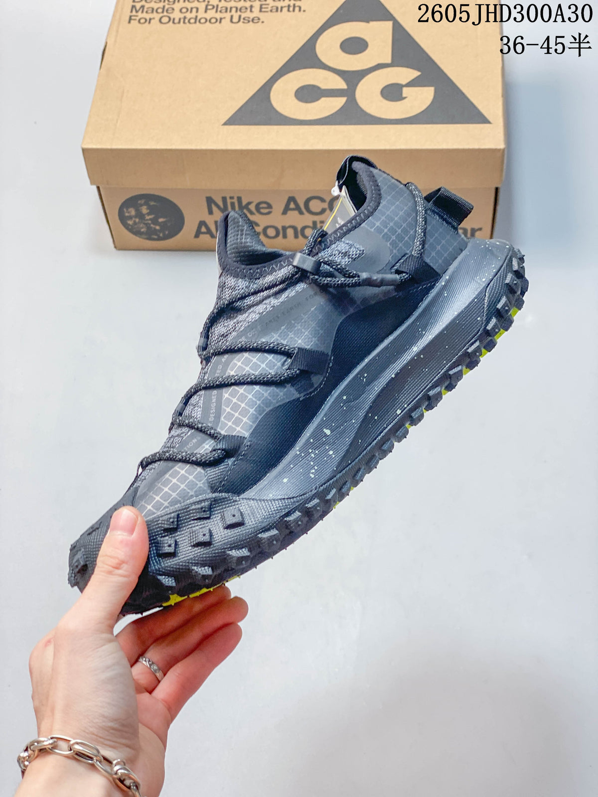 Side view of the gray low-top outdoor shoe and rugged outsole