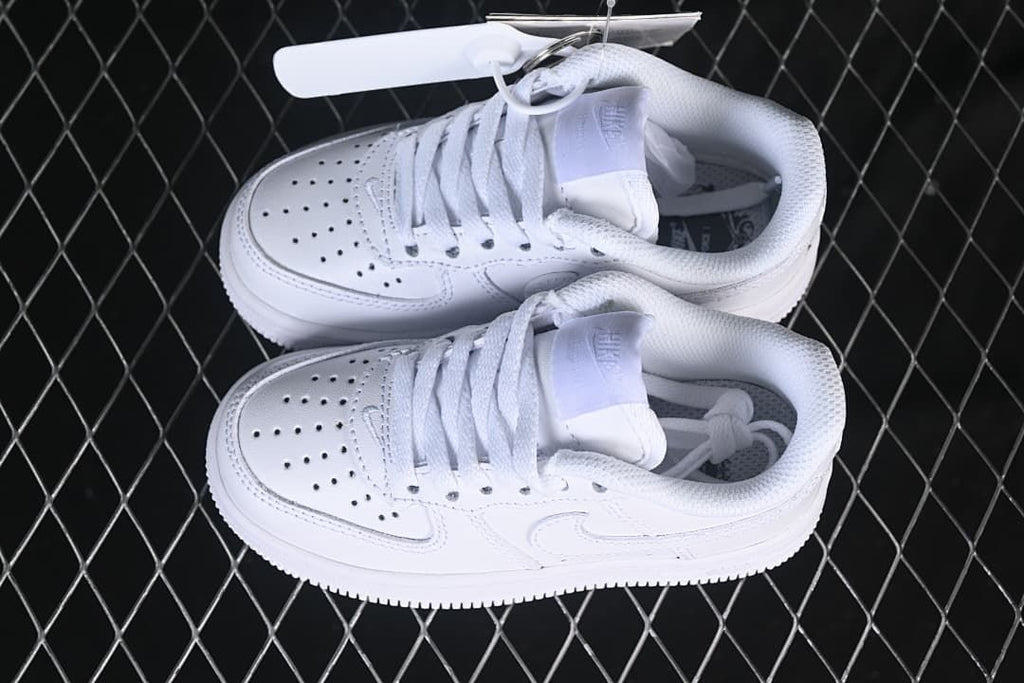 Pair of white kids’ low-top sneakers viewed from above