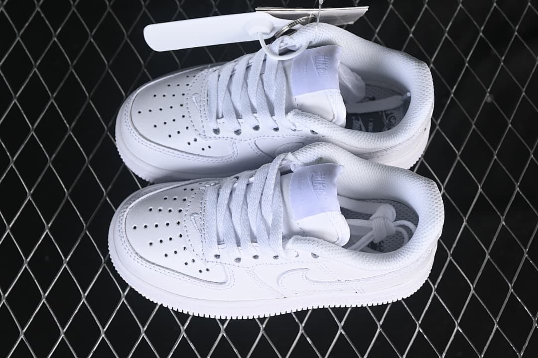 Pair of white kids’ low-top sneakers viewed from above