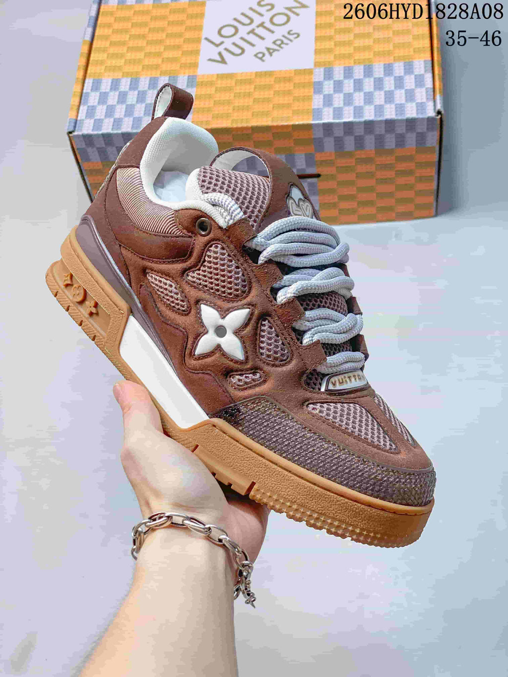 Angled side view of a brown Louis Vuitton Trainer sneaker with white side detailing