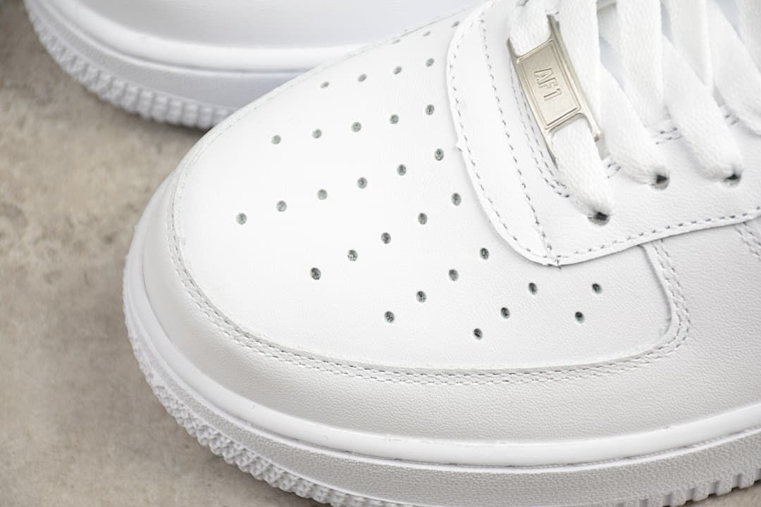 Perforated toe panel and stitched edges on the white sneaker.