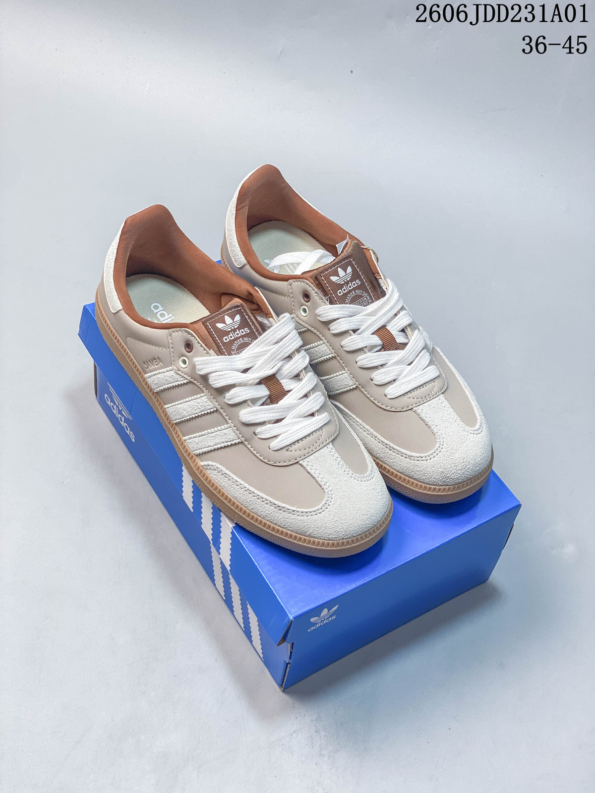 Pair of light neutral Adidas Samba OG sneakers with white details and gum-colored soles