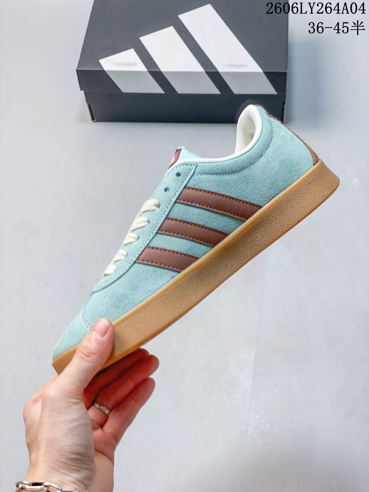 Side profile of the blue adidas VL Court Classic sneaker with brown stripes and gum-colored sole