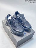 Pair of dark gray Kailas FUGA EX3 BOA trail shoes on a box, showing their dial closures and mesh-style uppers.