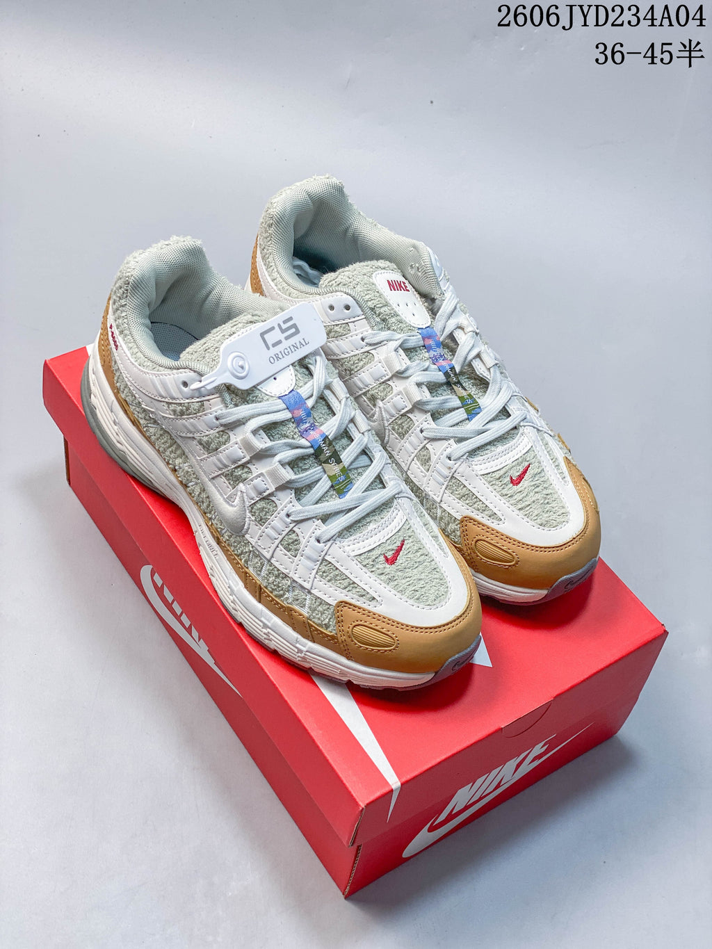 Pair of Nike P-6000 sneakers in light green, white, and tan, shown on a red box.