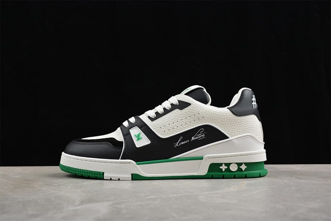 Side view of the white, black and green LV Trainer sneaker.