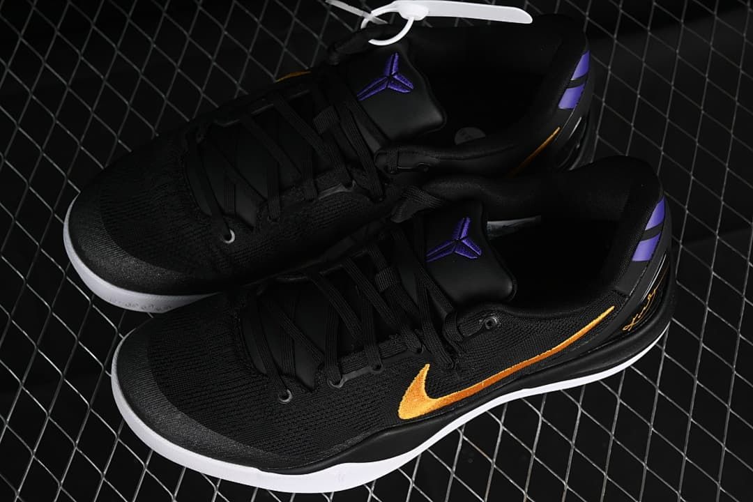 Pair of black Kobe 8 Protro shoes with gold and purple details