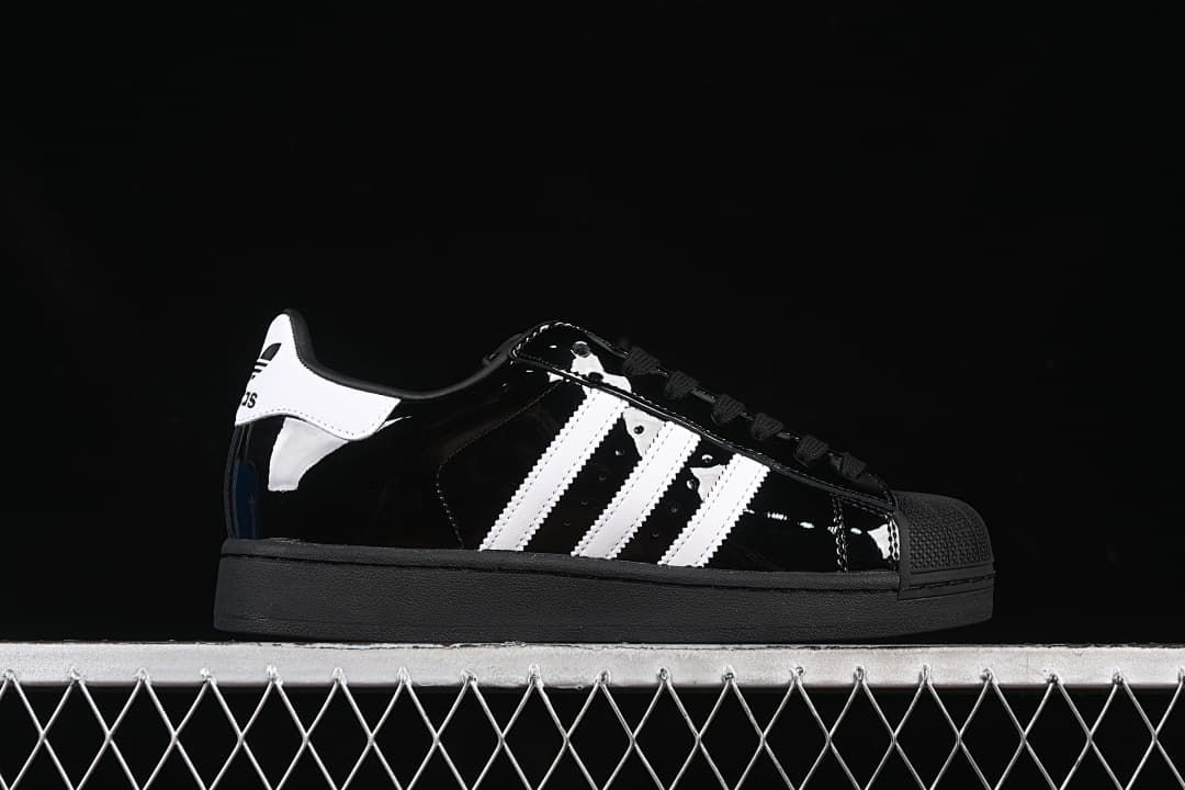 Side profile of a black Adidas Superstar II sneaker with white stripes