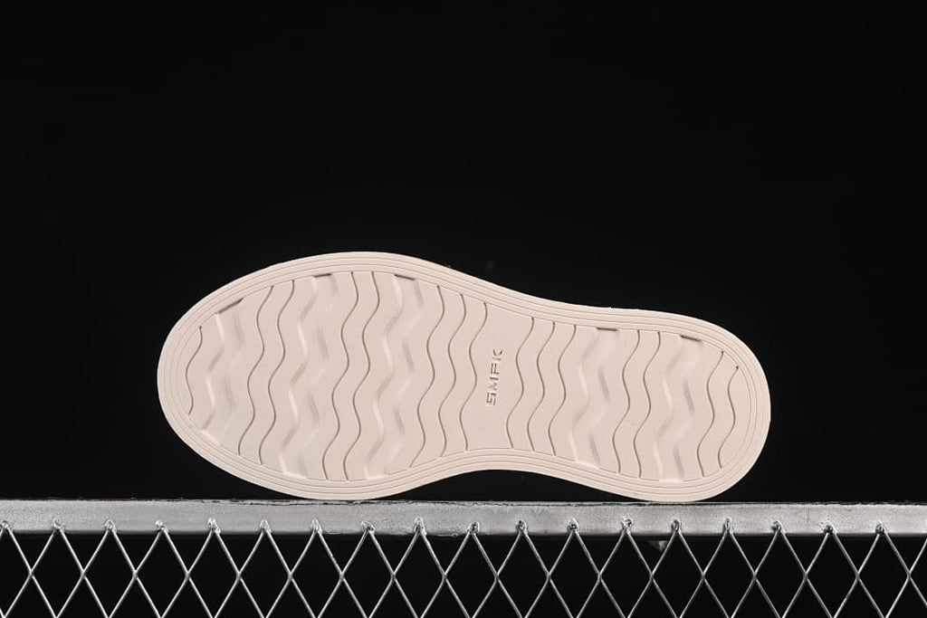 Underside of the sneaker showing the wavy tread pattern and SMFK marking.