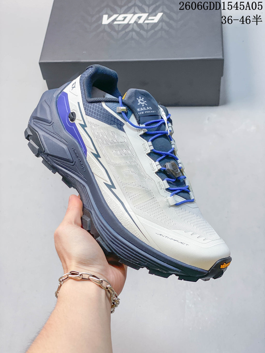 Angled side view of the white, blue, and gray Kailas trail shoe.