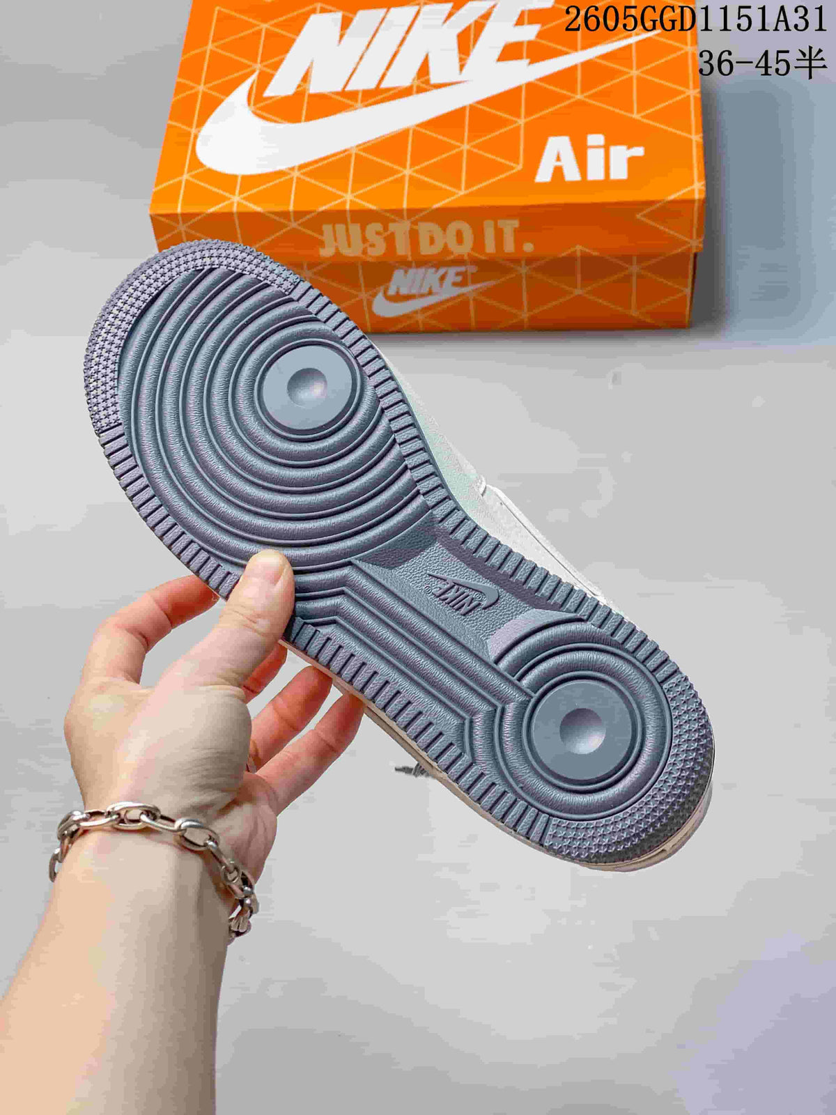 Close-up of the sneaker outsole with circular tread and an orange shoe box in the background