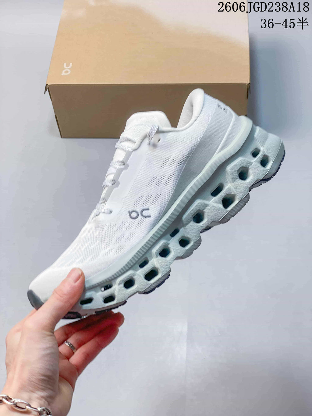 Side view of the white sneaker with a sculpted, open-section sole