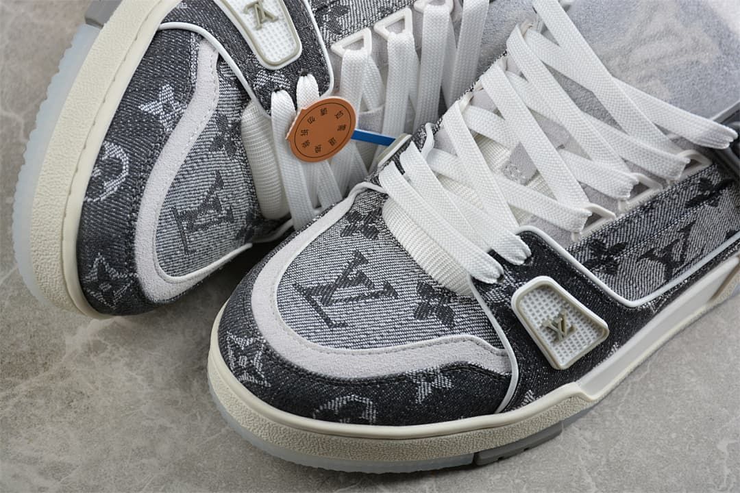Close-up of the patterned toe, light trim, and lace area on the sneakers.