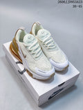 Pair of white and gold Nike Air Max 270 sneakers displayed on a shoebox