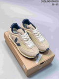 Pair of beige and navy Veja Esplar low-top sneakers displayed on a shoebox