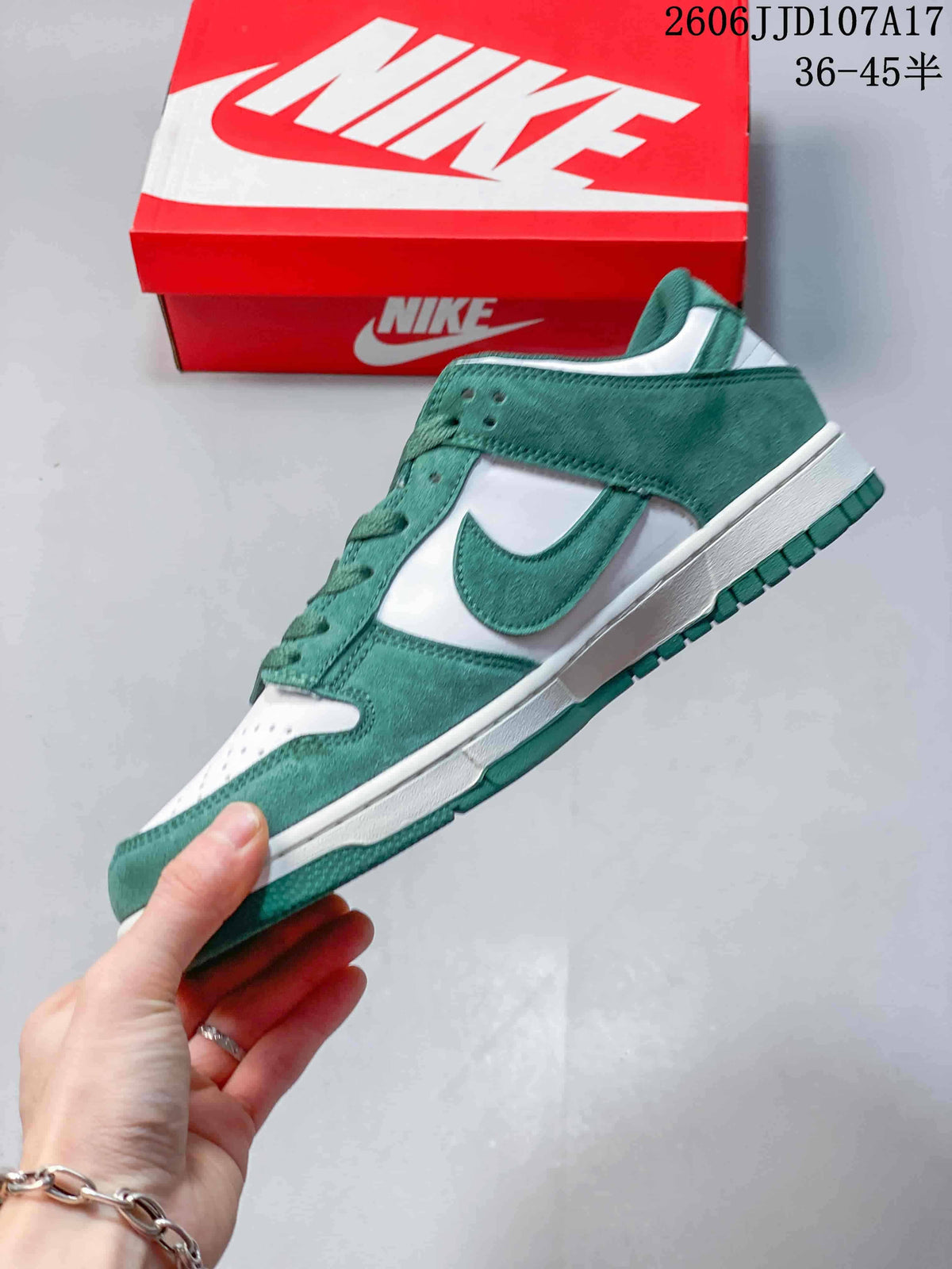 Side view of a green and white low-top sneaker with a Swoosh