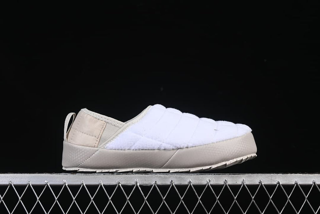 Side profile of the mule showing its quilted upper and beige heel