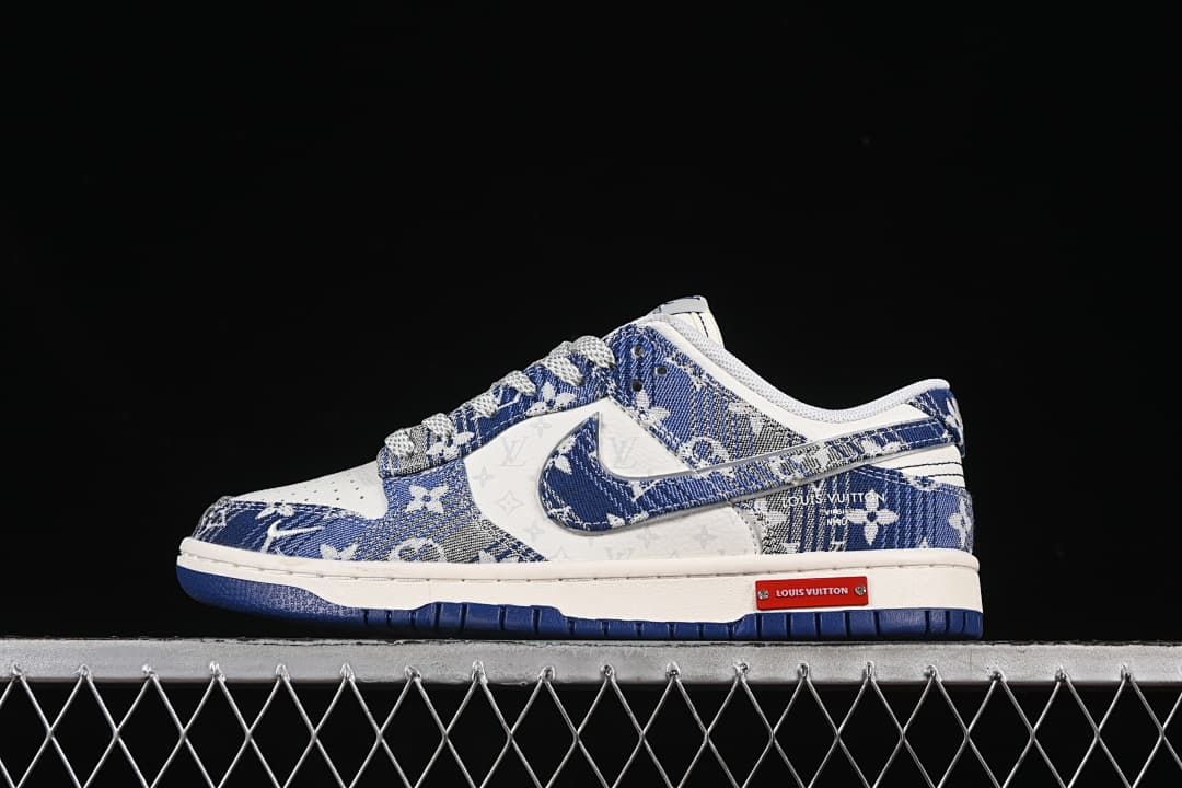 Side view of a blue-and-white patterned Nike SB Dunk Low sneaker with white midsole and blue outsole