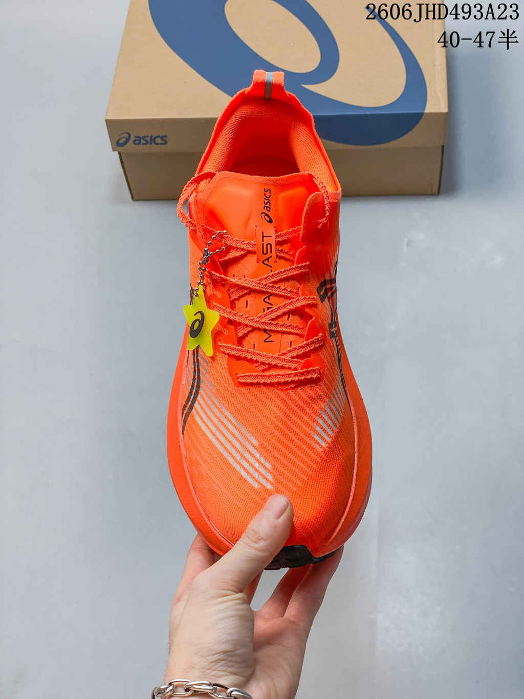 Top view of an orange lace-up running shoe