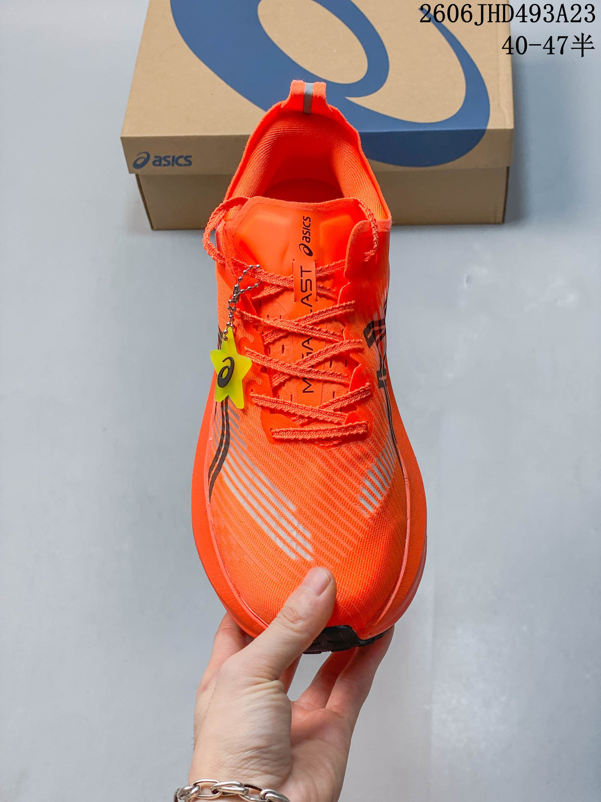 Top view of an orange lace-up running shoe