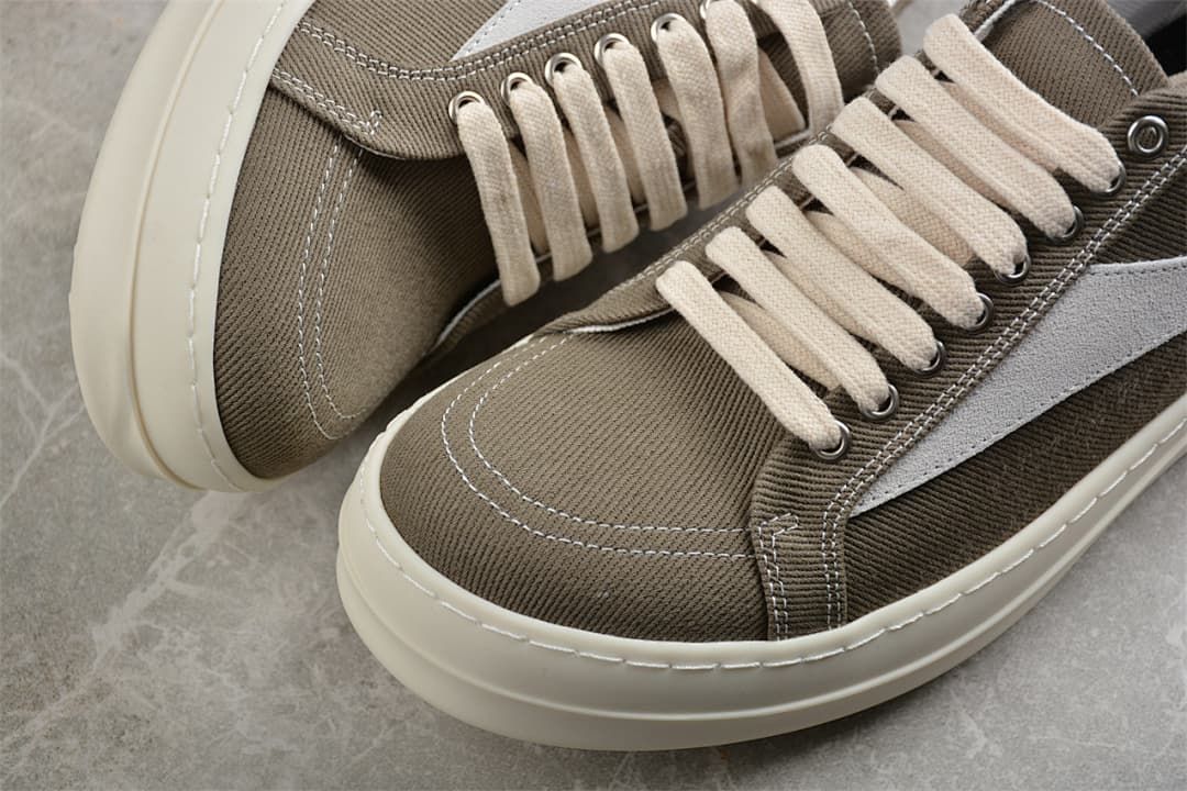 Close-up of the brown canvas toe, cream laces, stitching, and thick off-white sole