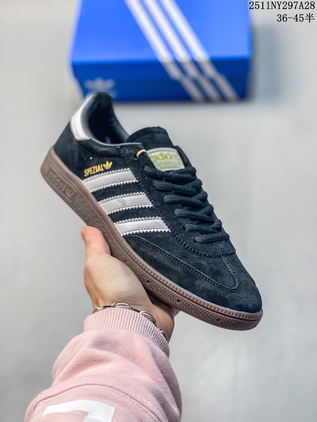 Angled close-up of the Adidas Handball Spezial, showing its side stripes, branding, and brown outsole.