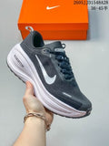 Dark gray Nike Vomero Plus shoe with a white swoosh and light-colored layered sole.