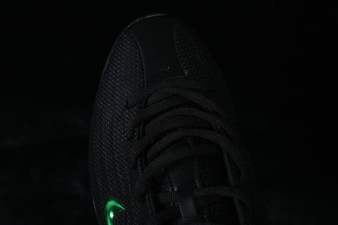 Top view of the black sneaker showing its laces and textured upper.