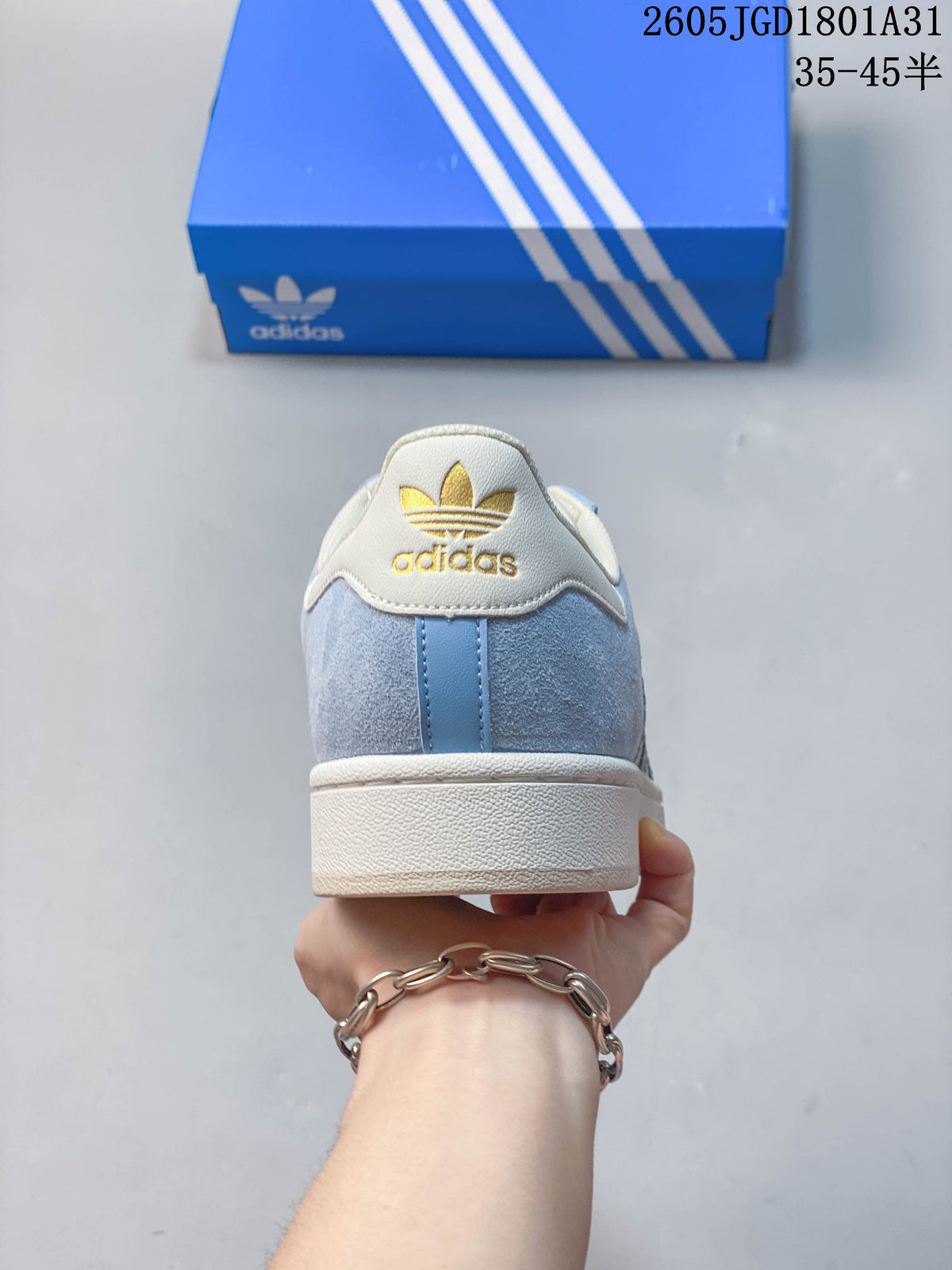 Rear view of a light blue Campus 00s sneaker with a cream heel tab and gold Adidas Trefoil branding.