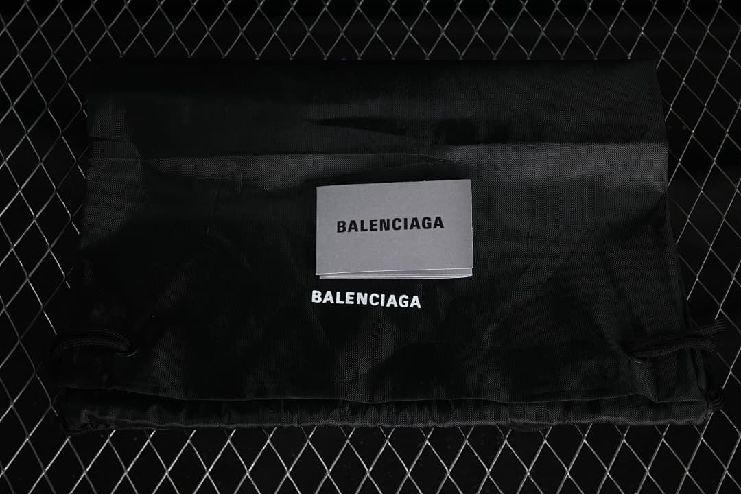 Black branded fabric bag and printed card pictured with the sneakers.