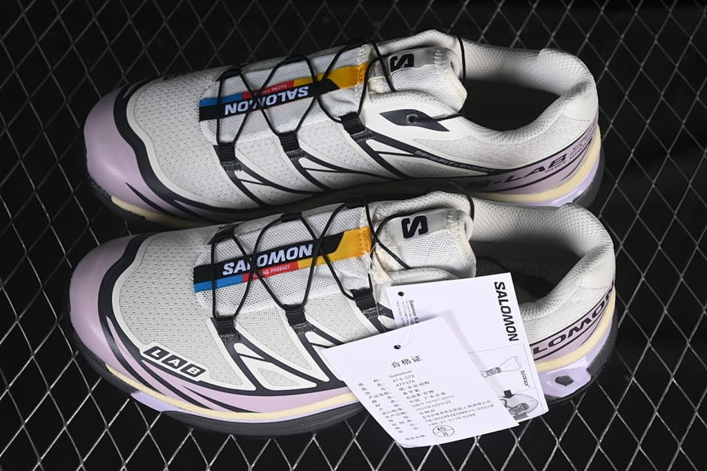 Pair of white and lilac Salomon XT-6 sneakers with product tags
