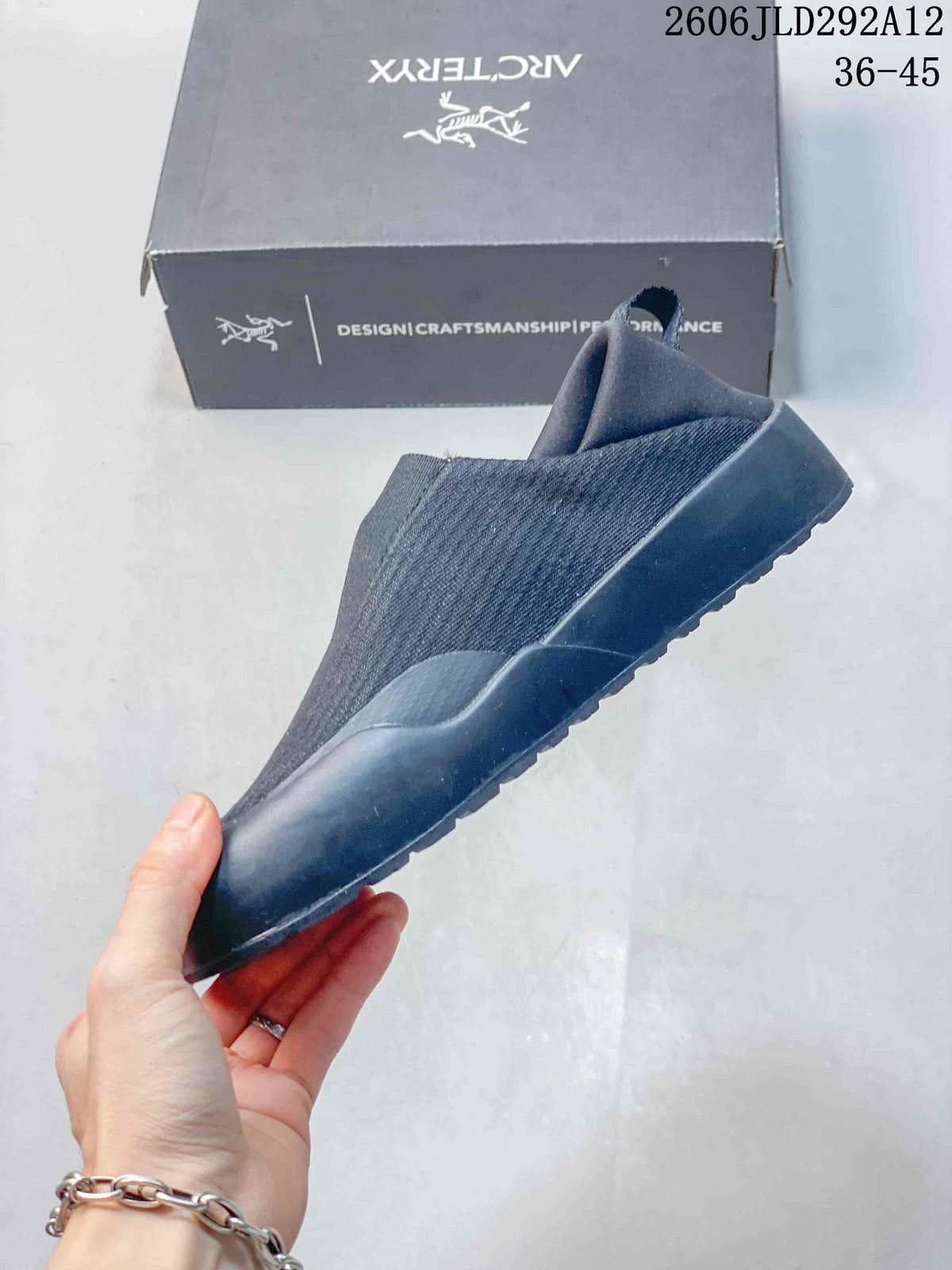 Side view of a gray slip-on shoe with a low-profile sole